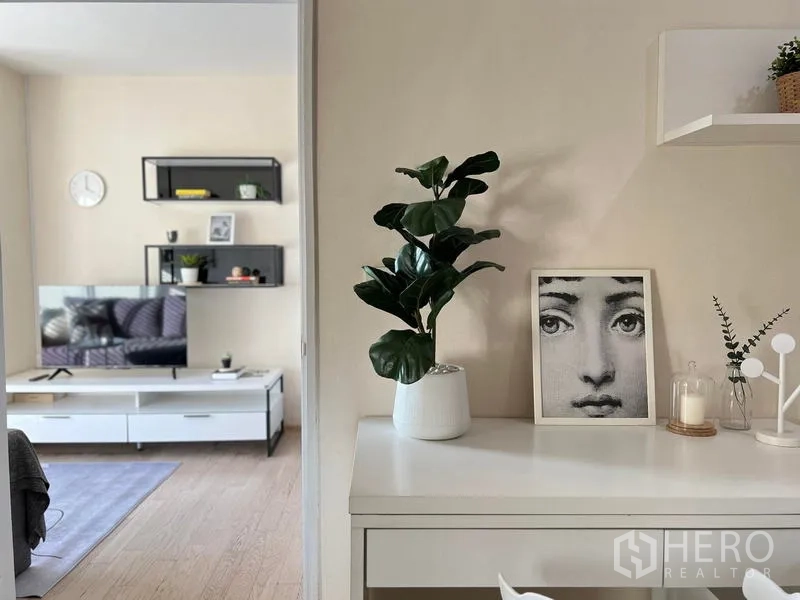 Condominium for rent in Khlong Toei, Bangkok - Work desk with potted plant overlooking the living room and TV cabinet.