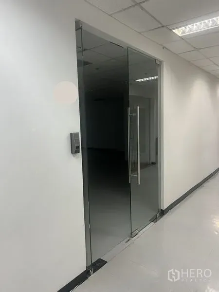 Office Space for rent in Watthana, Bangkok - Glass-door entrance to a bright office suite with keycard access and tiled floors.