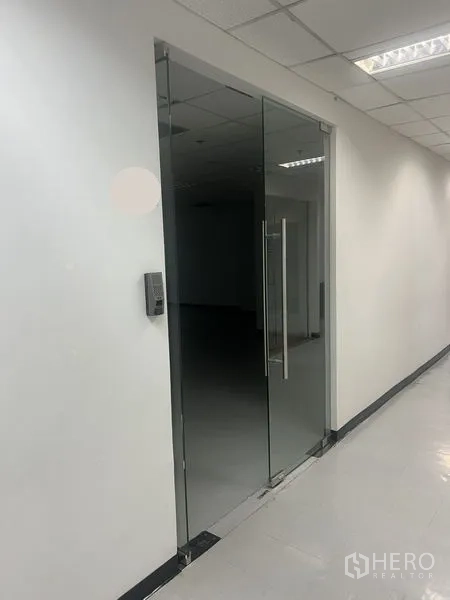 Office Space for rent in Watthana, Bangkok - Glass-door entrance to a bright office suite with keycard access and tiled floors.