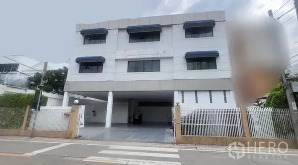 Standalone for rent in Khlong Toei, Bangkok - Front facade of modern three-storey standalone building with security fence.