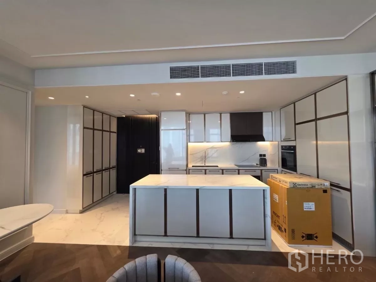 Condominium for rent - Compact powder room with marble walls, round basin, and wall-hung toilet.