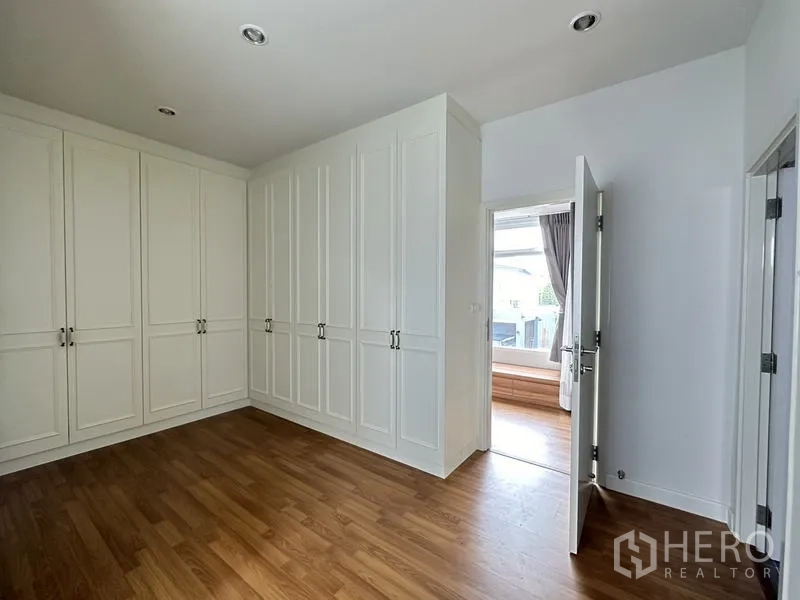 Detached House for sale in Lam Luk Ka, Pathum Thani - Walk-in wardrobe room with floor-to-ceiling white cabinets.