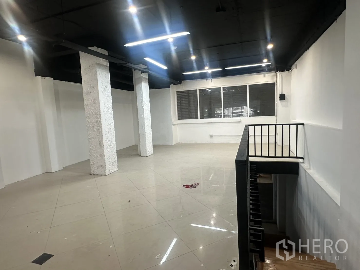 Retail Space for rent in Pathum Wan, Bangkok - Upper floor angle showing the stair opening and bright windowed frontage.