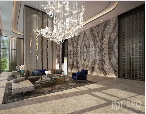 Condominium for sale in Watthana, Bangkok - Grand lobby with sculptural chandelier, marble feature wall and plush seating areas looking onto the garden.