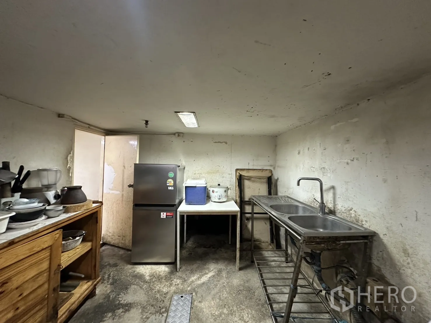Retail Space for rent in Watthana, Bangkok - Prep room with double stainless sink, countertop, and refrigerator.