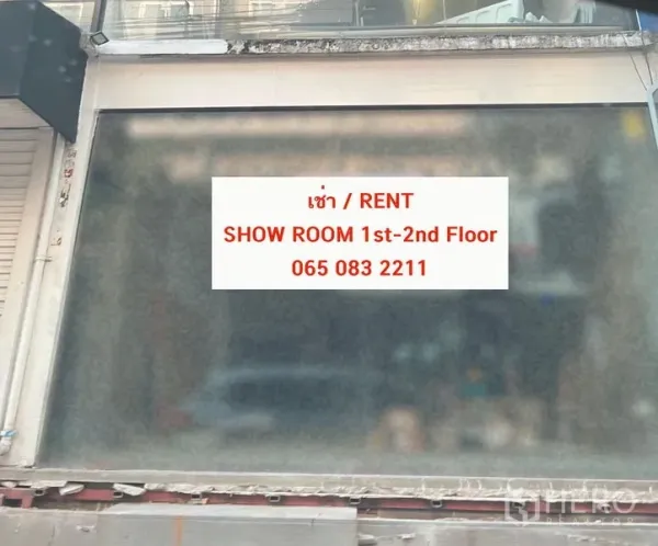 Retail Space for rent in Watthana, Bangkok - Ground-floor storefront with frosted glass and a rental showroom sign displayed.
