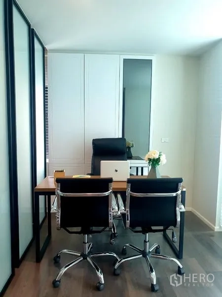 Home Office for rent - Compact executive office with desk, laptop and two visitor chairs.