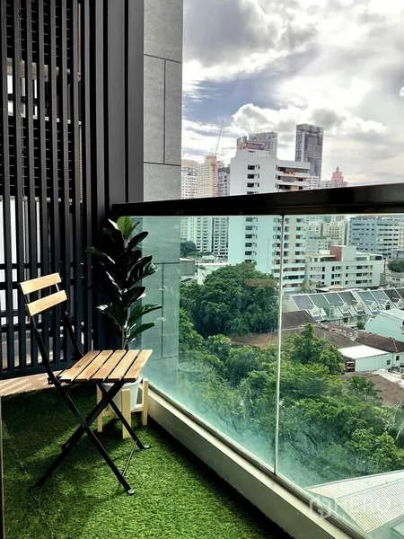 Condominium for rent or sale - Private balcony with a chair, glass railing and city skyline view near Phrom Phong.