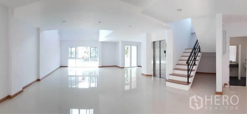 Home Office for rent in Prawet, Bangkok - Bright open-plan interior with glossy tile floors, large windows, sliding doors, staircase and private elevator.