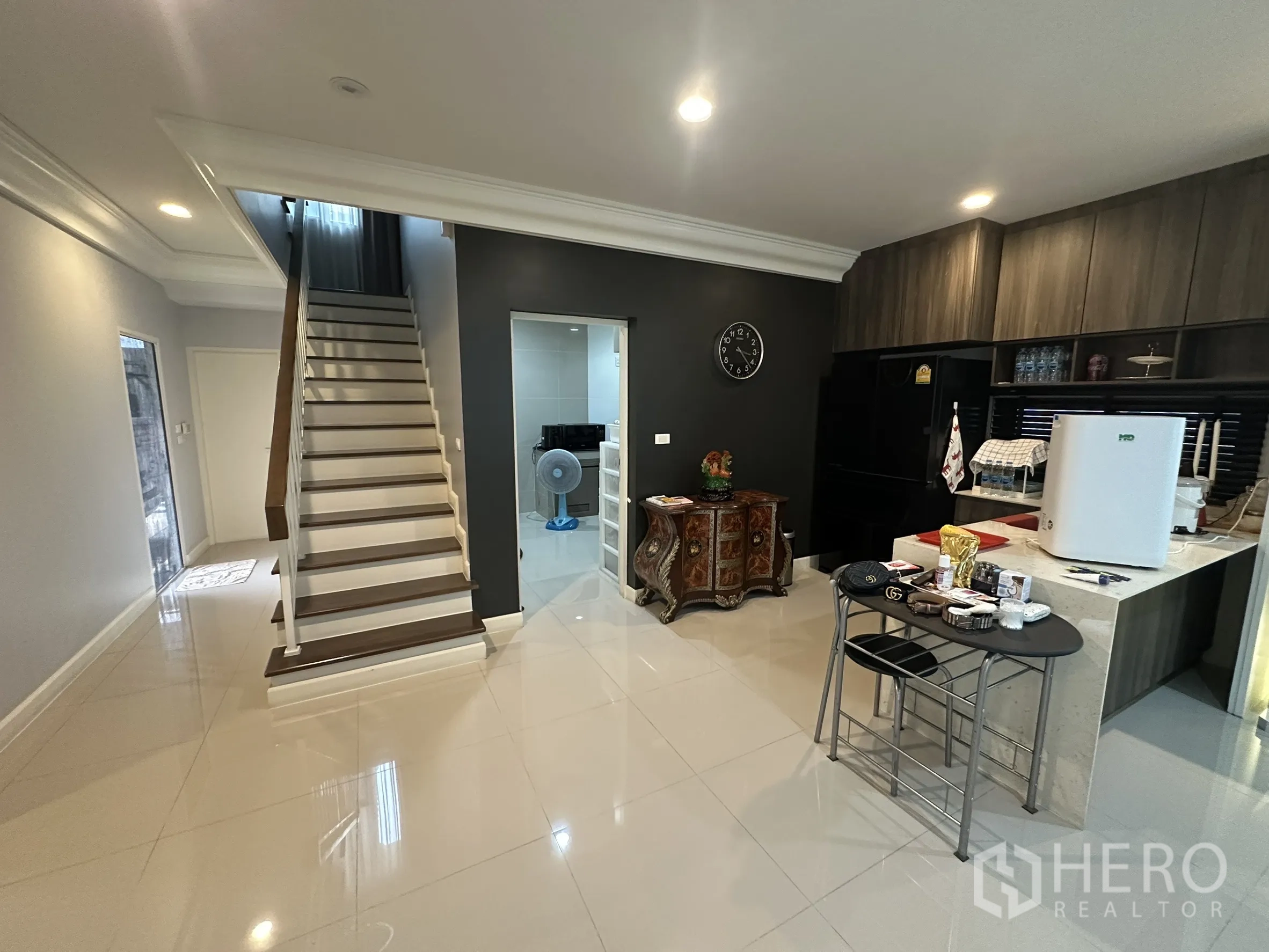 Detached House for rent in Lam Luk Ka, Pathum Thani - Staircase hall facing pantry and dark-wood kitchen cabinetry.