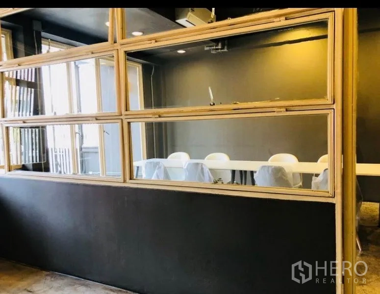 Home Office for rent in Huai Khwang, Bangkok - Glass-partitioned conference room framed in light wood.