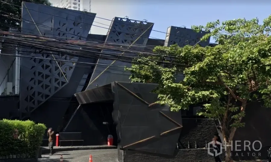 Retail Space for rent in Watthana, Bangkok - Striking black contemporary retail building with angular geometric façade, trees, and driveway in Ekkamai, Bangkok.