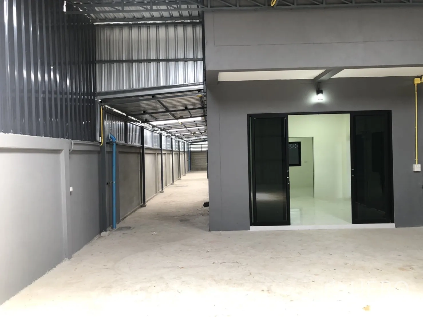 Warehouse for rent in Lam Luk Ka, Pathum Thani - Entry to the office suite from the yard with twin sliding doors and wide circulation space.