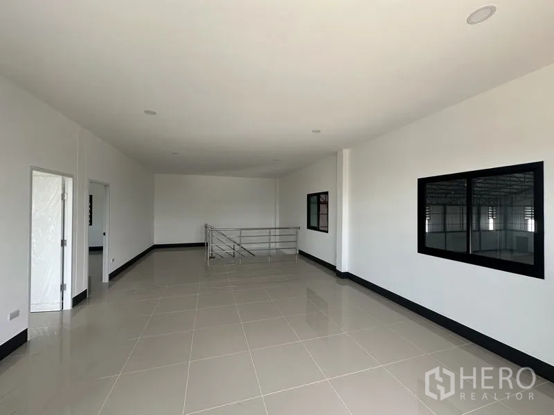 Factory for rent or sale in Sai Noi, Nonthaburi - Second‑floor office space with railing and windows looking into the factory floor.