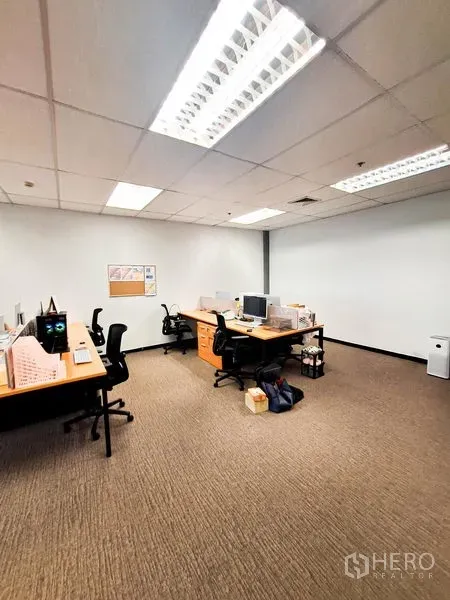 Office Space for rent in Bang Na, Bangkok - Private office area featuring multiple workstations, task chairs and bright fluorescent ceiling lighting.