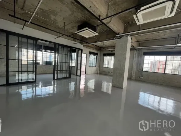 Office Space for rent in Khlong Toei, Bangkok - Corner office with sliding glass partitions, glossy floors and multiple windows overlooking Bangkok city.