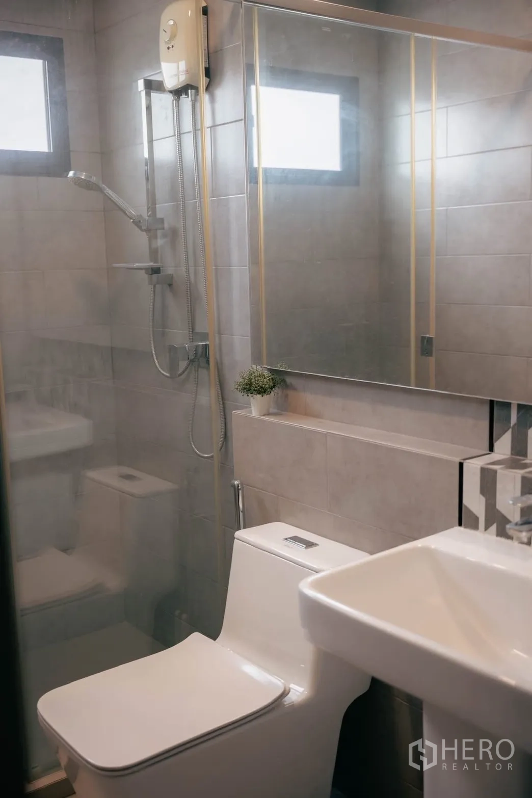 Detached House for rent or sale in Bang Phli, Samut Prakan - Bathroom with glass shower, pedestal basin and small plant decor.
