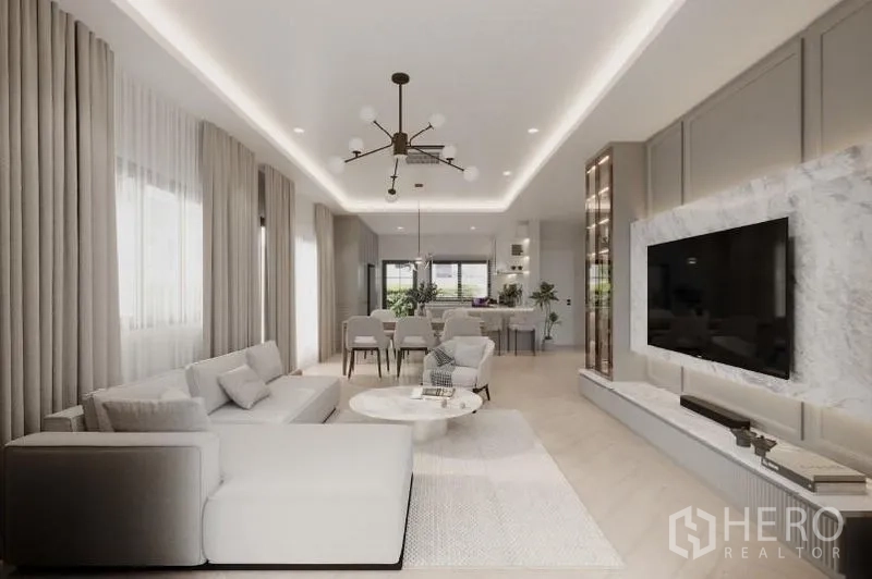 Detached House for rent in Bang Phli, Samut Prakan - Long living space with L-shaped sofa, round coffee table and recessed ceiling lights.