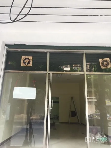 Retail Space for rent in Khlong Toei, Bangkok - Street‑facing glass shopfront with sliding doors and ventilation fans above the entrance.