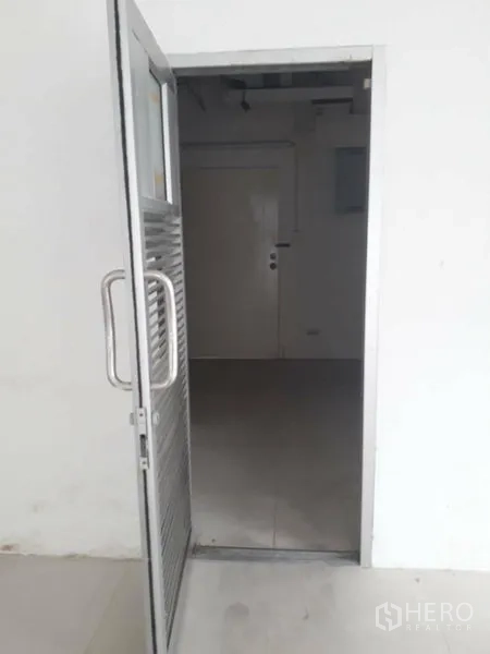 Retail Space for rent in Watthana, Bangkok - Metal service door opening to a back-of-house area within the unit.