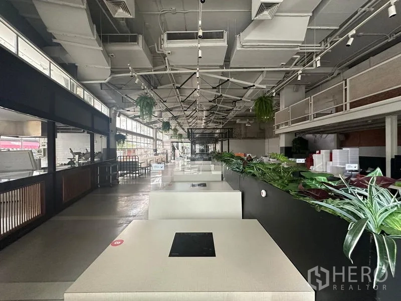 Retail Space for rent in Watthana, Bangkok - Loft-style retail hall with high ceilings, exposed ducting and booth seating.