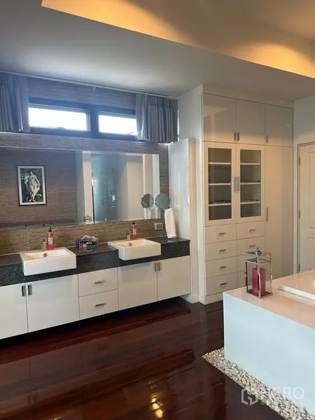 Detached House for sale in Saphan Sung, Bangkok - Contemporary bathroom with double vanity, bathtub and generous storage cabinetry.