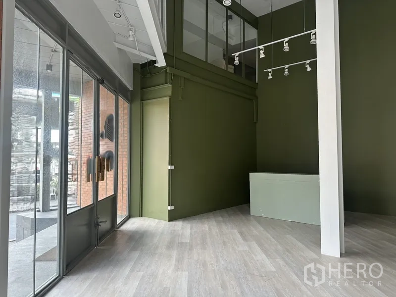 Retail Space for rent in Khlong Toei, Bangkok - Front entrance area with glass doors, green wall and suspended spotlight rails.