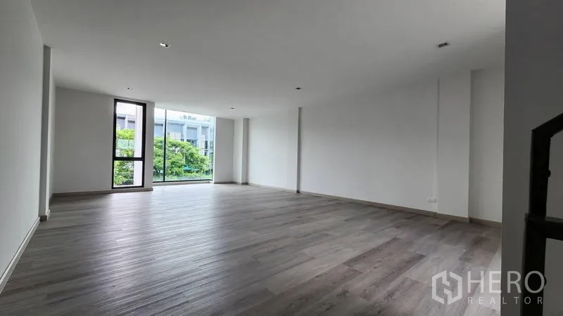 Home Office for rent - Large flexible workspace with wide window and wood-style flooring.