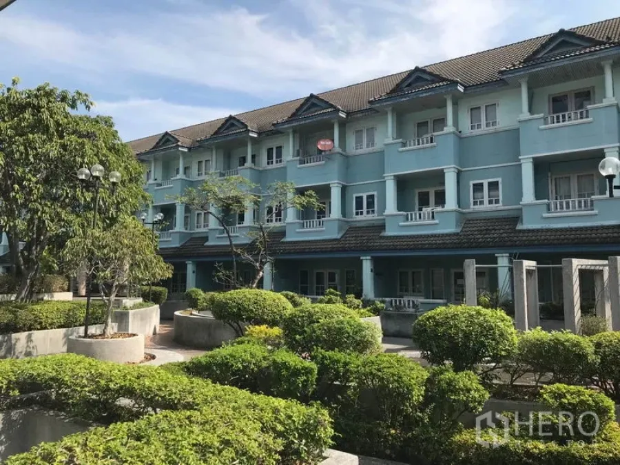 Office Space for rent in Khlong Toei, Bangkok - Low-rise blue building exterior with landscaped courtyard and greenery.