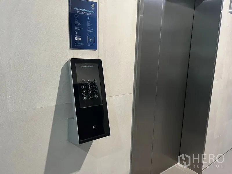 Office Space for rent - Destination-controlled elevator keypad next to stainless-steel lift doors.