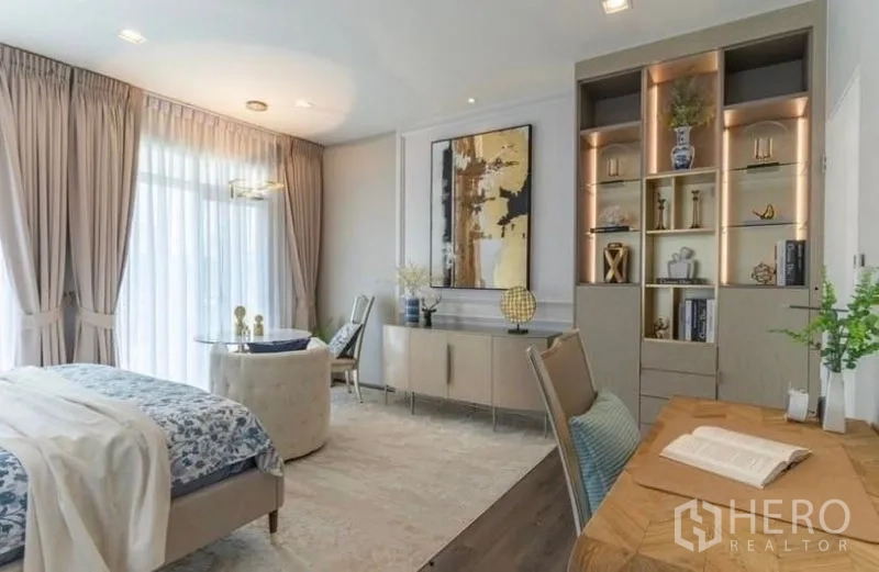 Detached House for rent in Bang Phli, Samut Prakan - Primary bedroom view with built-in illuminated shelving and work desk.