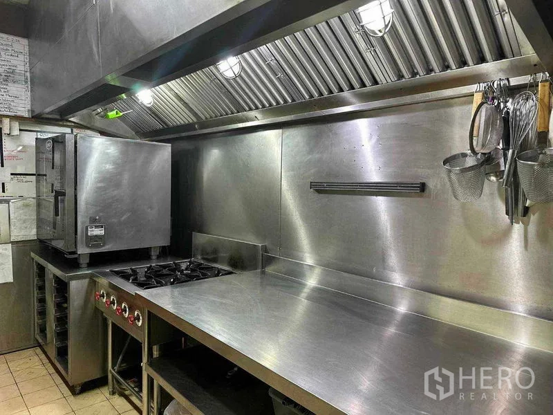Retail Space for rent in Watthana, Bangkok - Cookline with oven, four-burner stove and vent hood in commercial kitchen.