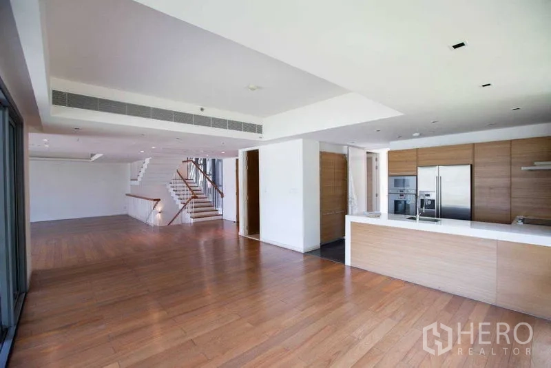 Condominium for rent in Yan Nawa, Bangkok - Modern open kitchen with island, built-in appliances and wood cabinetry.