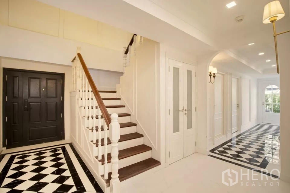 Condominium for sale in Watthana, Bangkok - Grand entry hall of Watthana condo with double doors, staircase and long corridor.