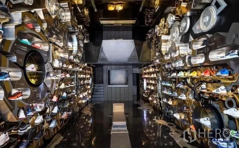 Shophouse for rent in Khlong Toei, Bangkok - High-end sneaker retail interior with mirrored floor and illuminated wall displays.