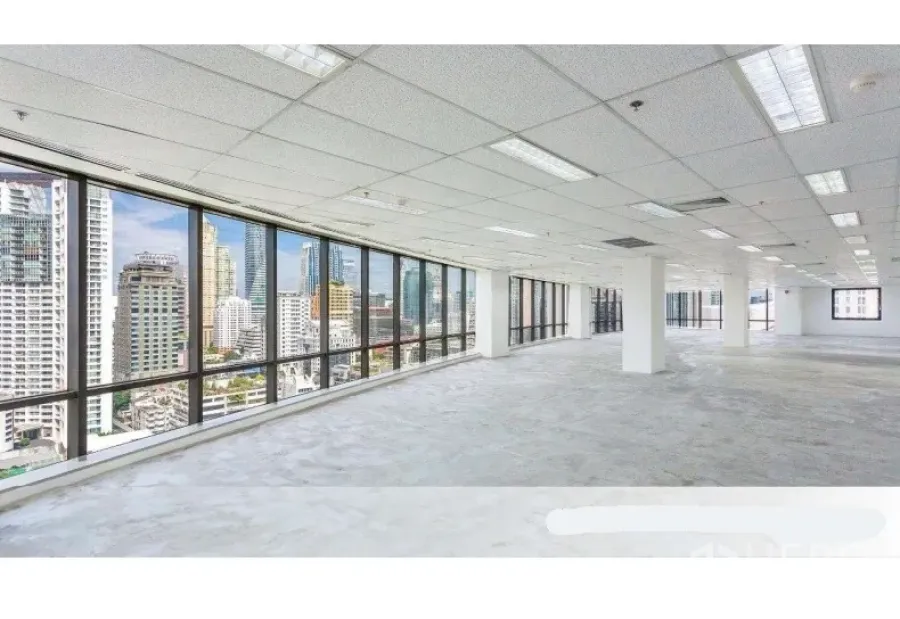 Office Space for rent in Pathum Wan, Bangkok - Large corner office with wraparound windows and panoramic Bangkok skyline views under a grid ceiling.