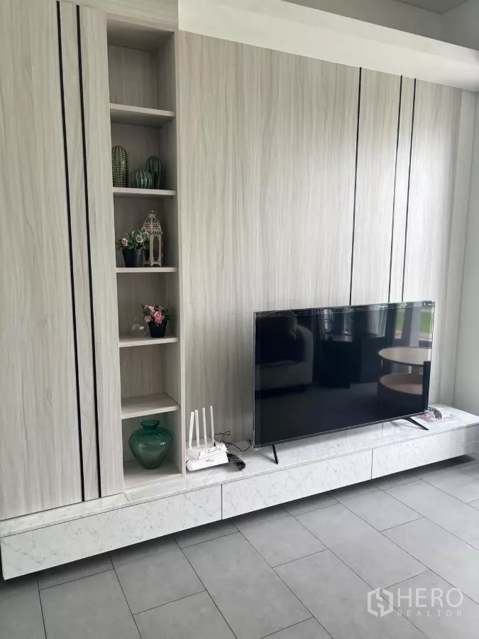 Condominium for rent or sale in Phaya Thai, Bangkok - Close‑up of modern built‑in TV cabinet with open shelving and marble‑style ledge.