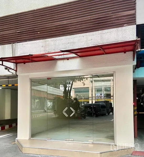 Retail Space for rent in Watthana, Bangkok - Street-level retail unit with full-height glass storefront and red awning in Watthana.