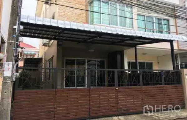 Home Office for rent in Lat Phrao, Bangkok - Home office townhome facade with covered carport, sliding gate and metal fence.