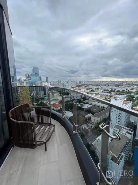 公寓 出租在Ratchathewi, Bangkok - 阳台一角放置休闲椅，视野开阔俯瞰市中心。