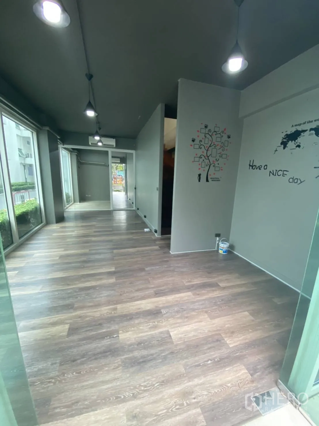 Retail Space for rent in Huai Khwang, Bangkok - Ground floor gallery-like space with pendant lighting and window walls.