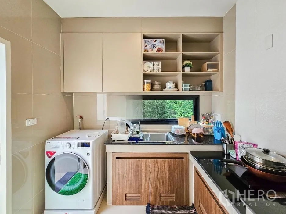 Detached House for sale in Lam Luk Ka, Pathum Thani - Secondary Thai kitchen and laundry area with sink, window and washing machine.
