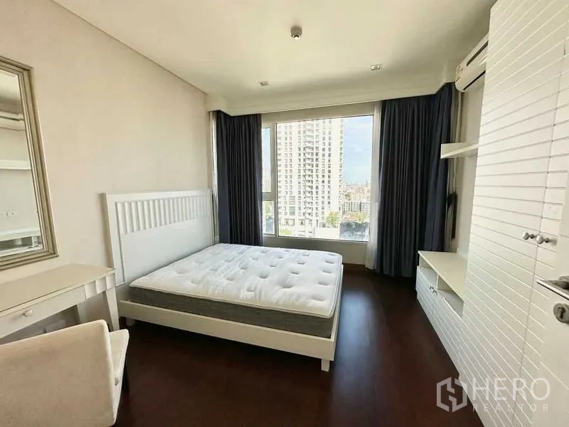 Condominium for rent in Watthana, Bangkok - Second bedroom with big window, white bed frame, and built-in shelving.