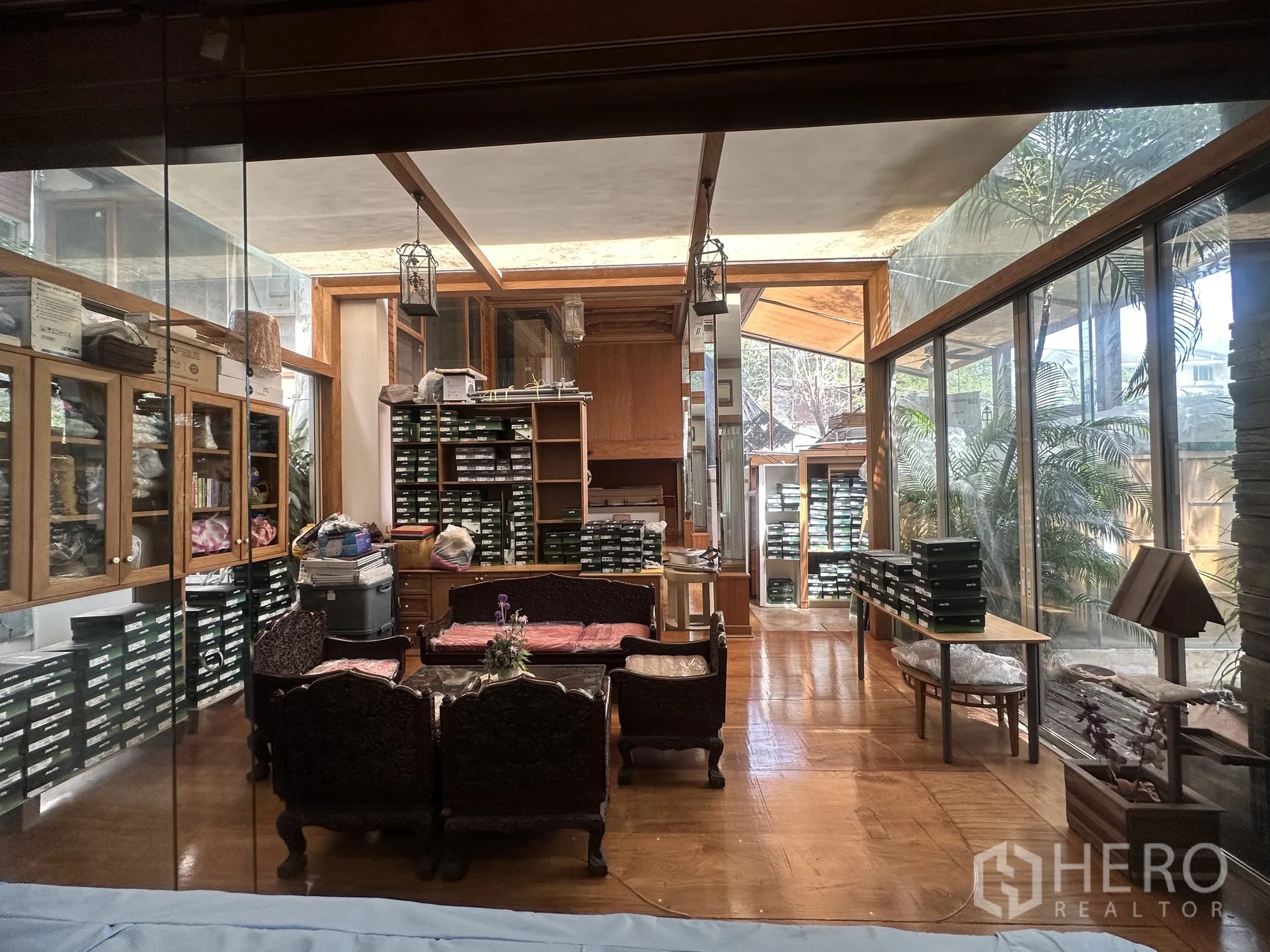 Detached House for rent in Lam Luk Ka, Pathum Thani - Glass-walled study or sunroom overlooking greenery with built-in shelves.
