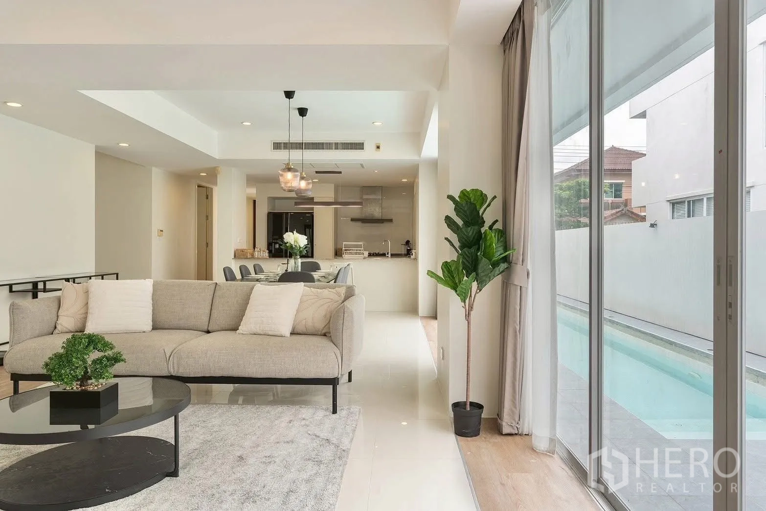 Detached House for rent in Saphan Sung, Bangkok - Living area overlooking poolside terrace and dining space.