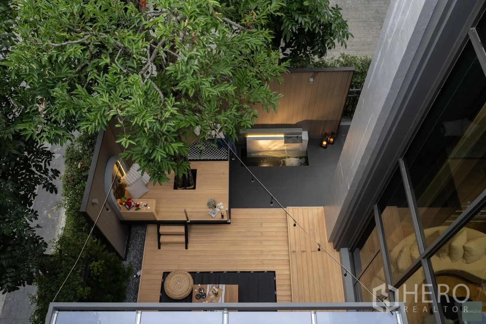 Detached House for rent or sale in Phra Khanong, Bangkok - Top-down view of the corner courtyard showing tree deck, water feature and outdoor counter.