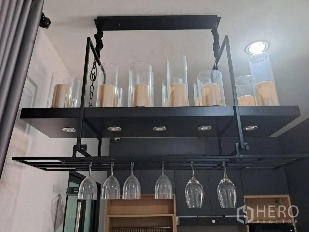 Townhouse for rent in Bang Kapi, Bangkok - Ceiling-mounted rack with candle holders and stemware above the counter.