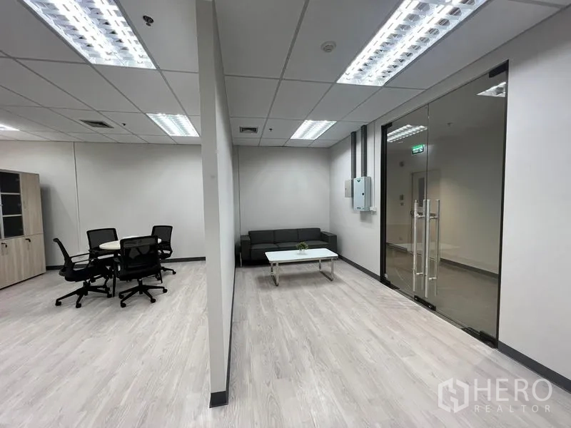Office Space for rent in Sathon, Bangkok - Entry zone with glass door, sofa seating and a meeting area under fluorescent lights.
