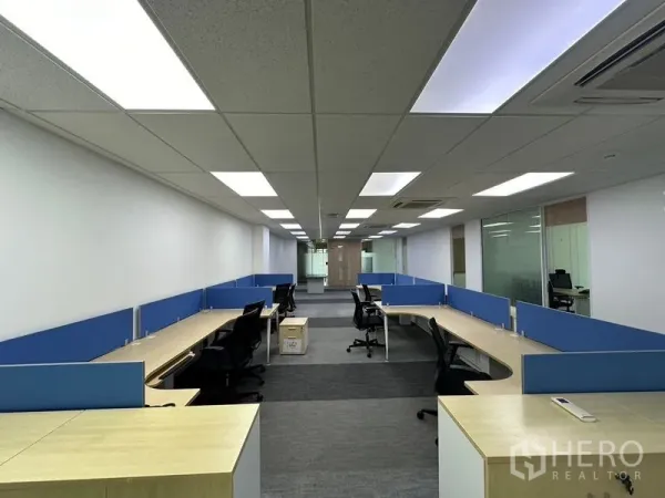 Office Space for rent - Fitted open-plan office with blue-partition workstations, LED ceiling lights and carpet tiles in Lat Krabang, Bangkok.