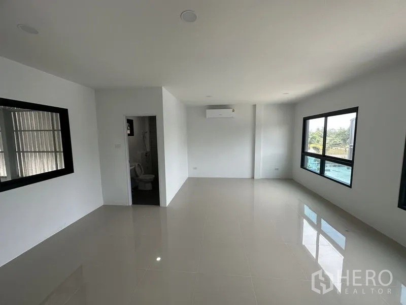 Factory for rent or sale in Bang Yai, Nonthaburi - Clean restroom with shower area, toilet and pedestal basin.